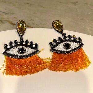 Evil eye earrings. Yellow fringe. Pearl and rhinestone accents. 2”x 3” long